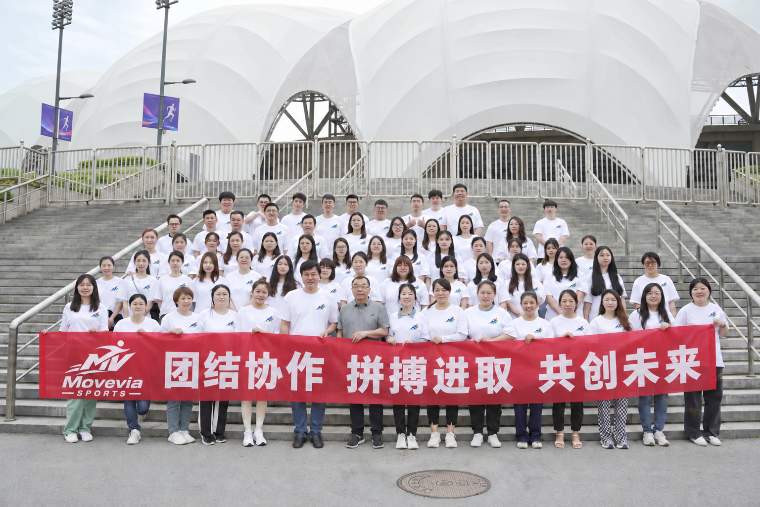 Team group photograph on outdoor steps